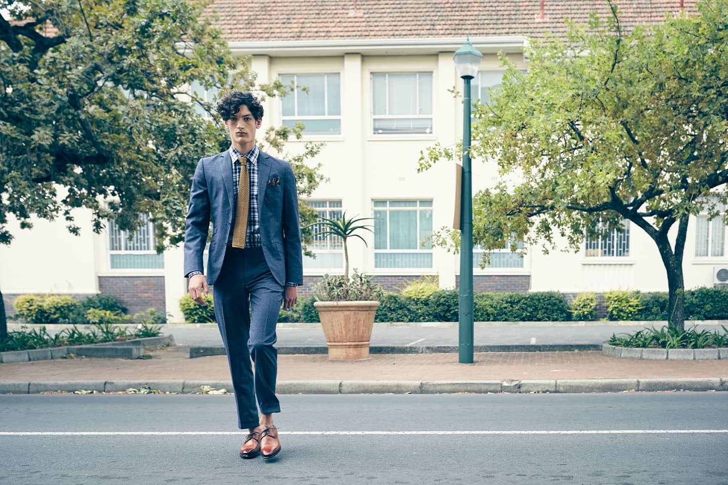 Junger Mann geht auf einer Straße im Maßanzug von Lewin